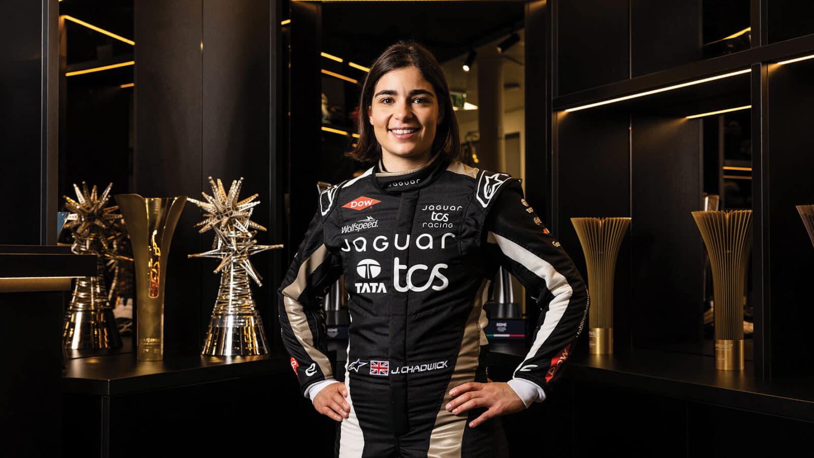 Jamie Chadwick in front of trophies