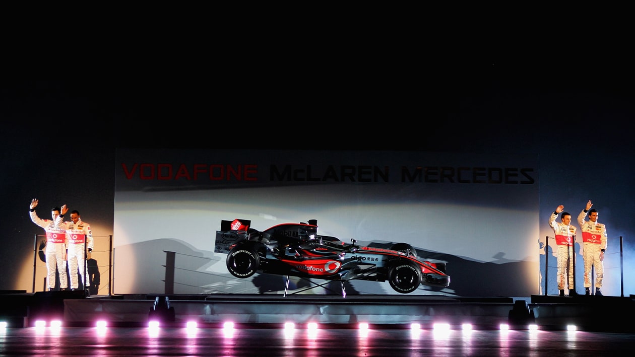 Lewis Hamilton and Fernando Alonso on stage alongside 2007 McLaren F1 car at Valencia launch