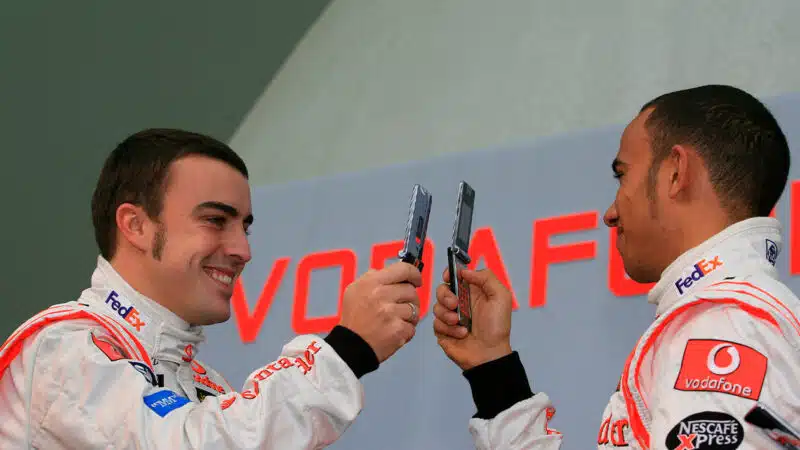 Lewis Hamilton and Fernando Alonso take pictures of each other at the 2007 McLaren F1 car launch