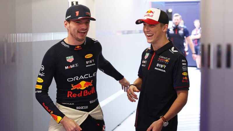 Liam Lawson with Max Verstappen in Red Bull pit gaarge during 2023