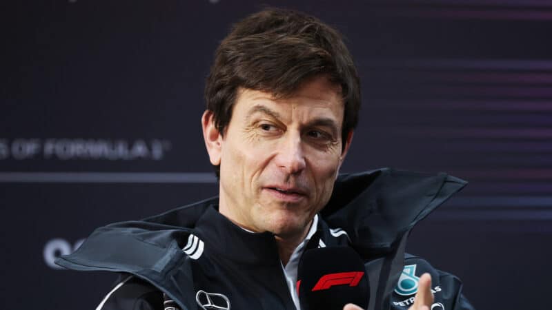 Toto Wolff talking in F1 paddock during 2025 preseason testing