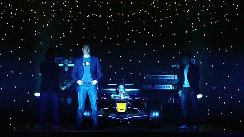 David Coulthard stands next to Red Bull F1 car and singer Pink at Melbourne team launch in 2005