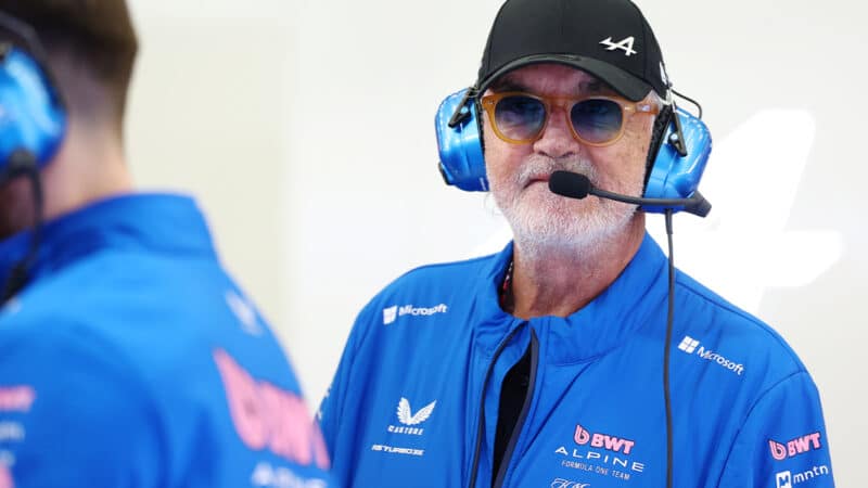 Flavio Briatore wearing headset in Alpine F1 garage during 2025 F1 preseason testing