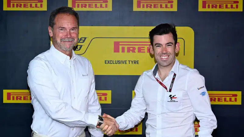 Giorgio Barber shakes hands with Carlos Ezpeleta after agreeing Pirelli deal for Moto2 and Moto3