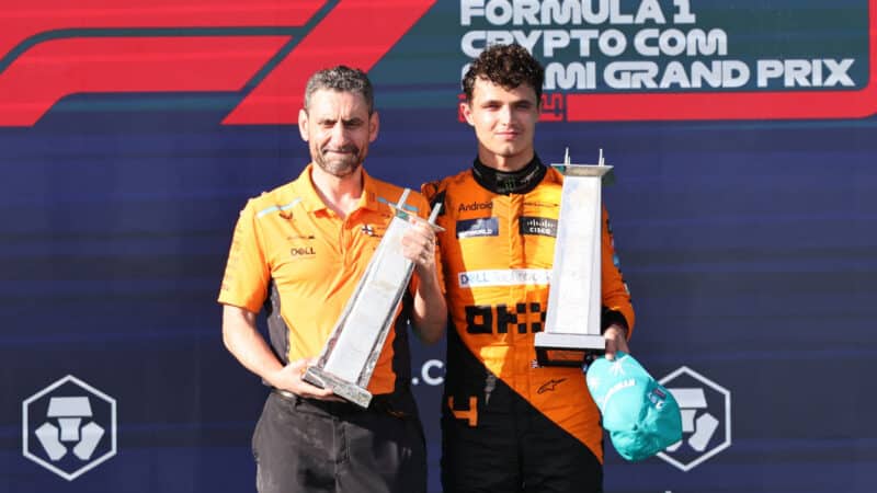 Lando Norris and Andrea Stella (both McLaren-Mercedes) on the podium with their trophies after the 2024 Miami Grand Prix