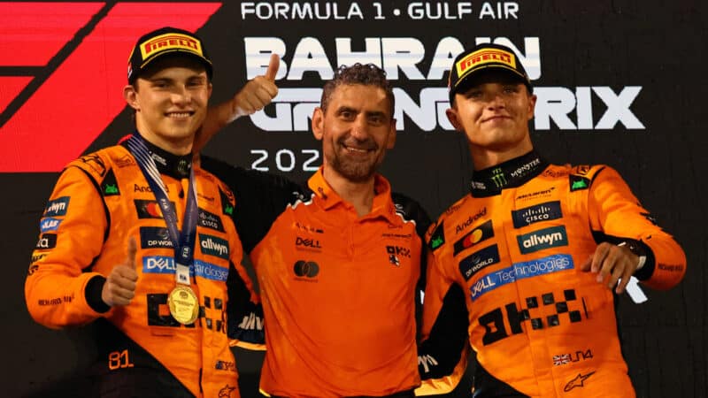 Oscar Piastri, Lando Norris, Andrea Stella (all McLaren-Mercedes) on the podium after the 2025 Bahrain Grand Prix