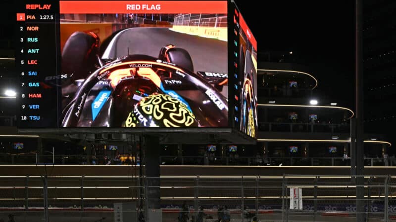 Spectators watch on a giant screen as Lando Norris crashes during the qualifying round for the 2025 Saudi Arabia Formula One Grand Prix