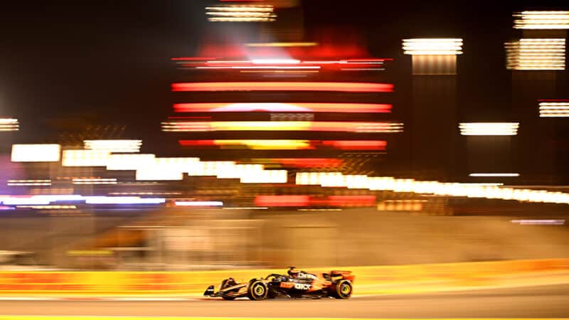 Lights blurred in background of Oscar Piastri in 2025 F1 Bahrain Grand Prix