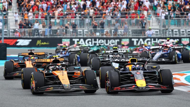 Max Verstappen (Red Bull-Honda) and Lando Norris (McLaren-Mercedes) lead the field at the start of the 2025 Miami Grand Prix