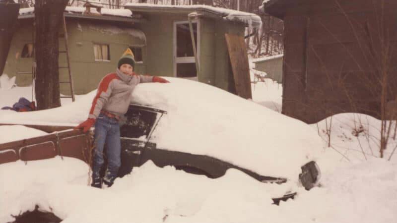 Black Porsche 911 under snow
