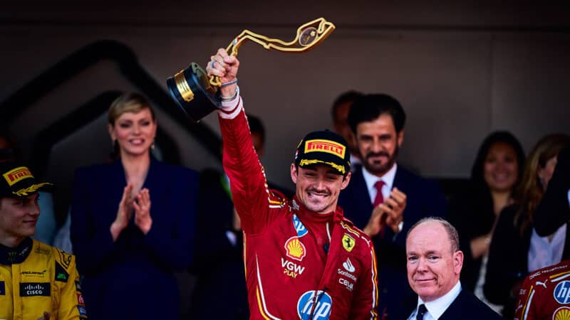 Charles Leclerc raises trophy in the air after winning the 2024 F1 Monaco Grand Prix