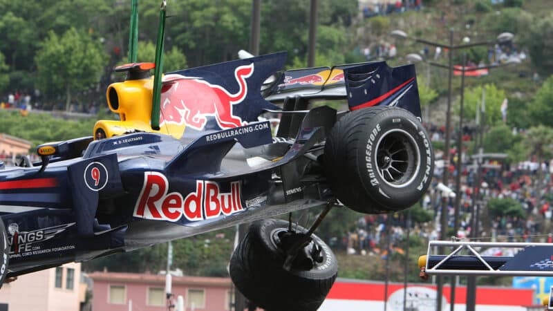 Damaged Red Bull of David Coulthard is lifted off the track at the 2008 F1 Monaco Grand Prix