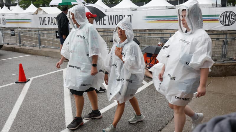 Fans wearing ponchos in the rain at 2024 Indy 500