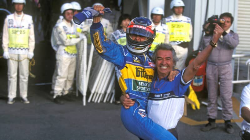 Flavio Briatore embraces Michael Schumacher after 1995 Japanese GP