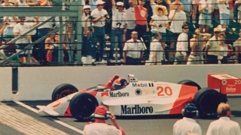 Emerson Fittipaldi of Brazil waves his fist as he crosses the finish line to win the Indianapolis 500