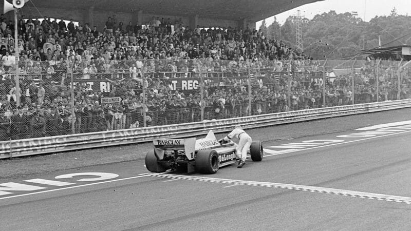 Thierry Boutsen pushes his car over the line at thw 1985 F1 San Marino Grand Prix