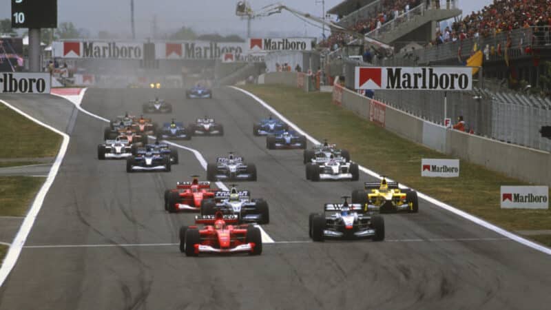 Michael Schumacher (Ferrari) and Mika Hakkinen (McLaren-Mercedes) lead the field into then first corner after the start of the 2001 Spanish Grand Prix