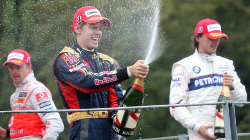 Robert Kubica (BMW), Lewis Hamilton (McLaren-Mercedes) and Sebatian Vettel (Toro Rosso-Ferrari) spraying the champagne on the podium after the wet 2008 Italian Grand Prix