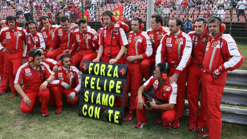Ferrari mechanics and race engineer Rob Smedley with a message for Felipe Massa before the 2009 Hungarian Grand Prix
