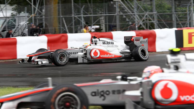 Lewis Hamilton (McLaren-Mercedes) with a damaged rear tyre and team mate Jenson Button in the wet 2011 Canadian Grand Prix