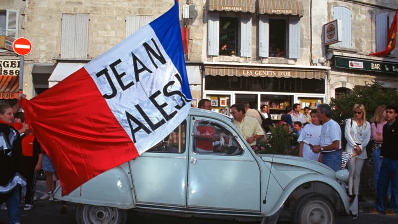 Citroen 2CV driver waves JEan Alesi flag in Avignon after the Ferrari F1 driver won the 1995 Canadian Grand Prix
