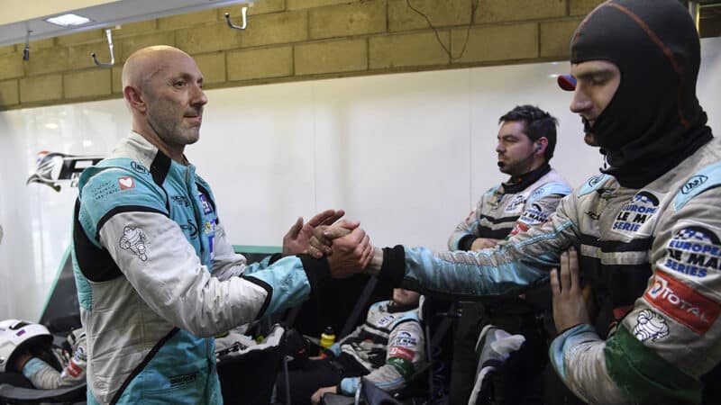 Fabien Barthez shakes hands with pitcrew at the Le Mans 24 Hours