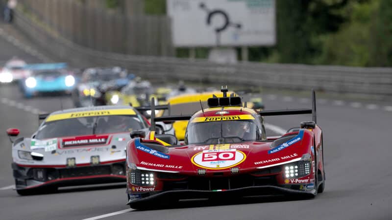 Ferrari Hypercar at the head of a line of cars during test day ahead of the 2025 Le Mans 24 Hours