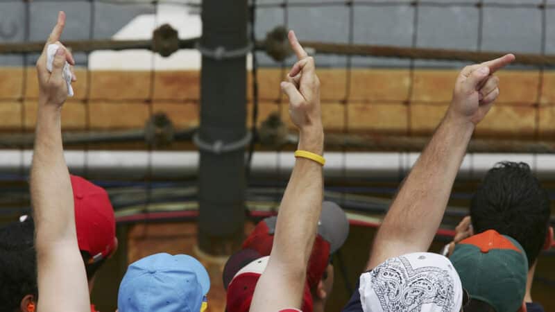 American fans display their feelings shortly after the start as both Ferrari cars pass by during the US F1 Grand Prix