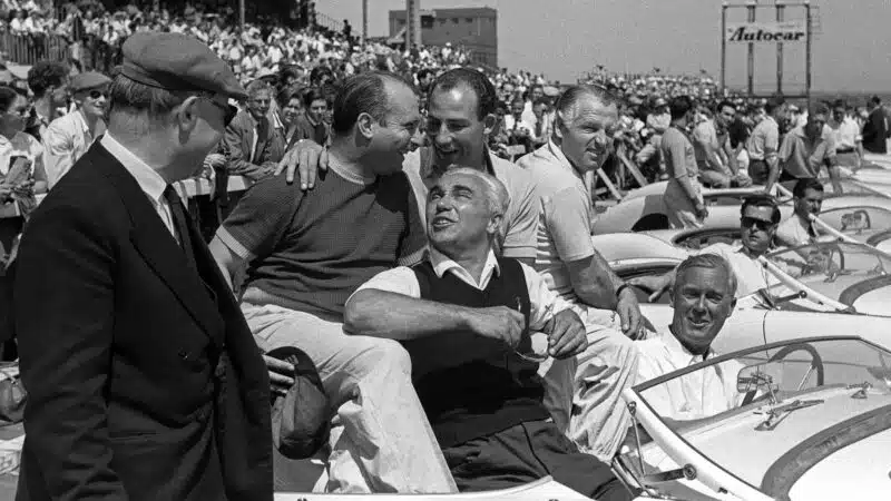 Juan Fangio and Stirling Moss embrace