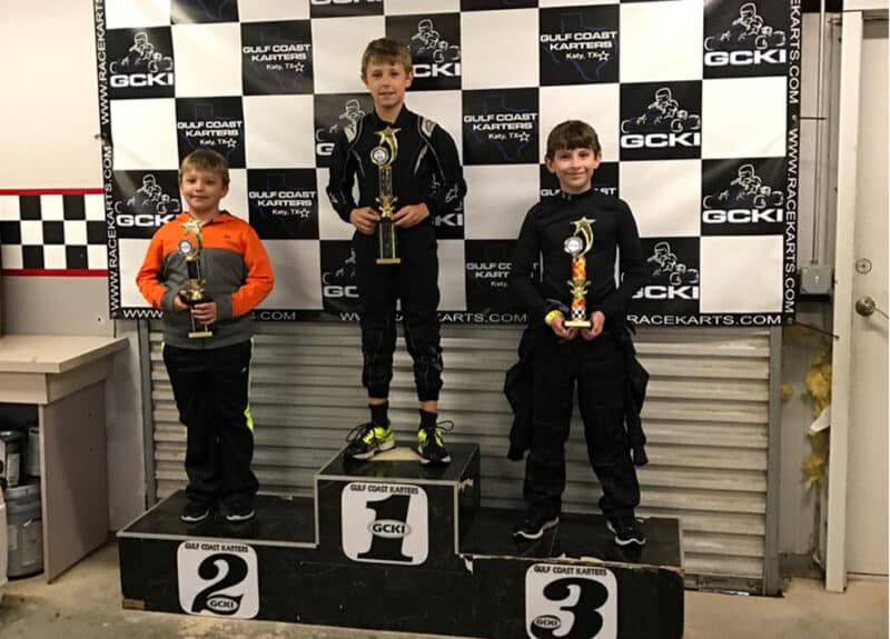 McKenzy Cresswell standing on the top of a podium after winning kart race in Katy Texas