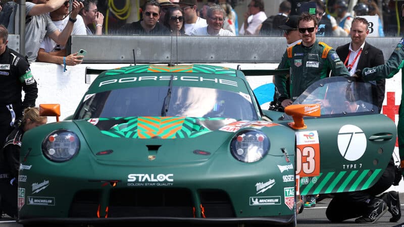 Michael Fassbender next to his Porsche 911 GT car at the Le Mans 24 Hours