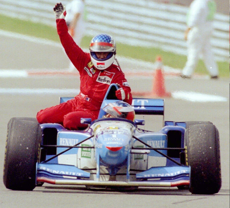 Michael Schumacher gives Jean Alesi a lift back to the pits after the Ferrari driver won the 1995 Canadian Grand Prix