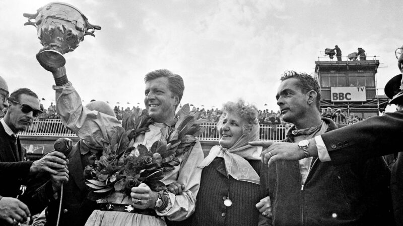 Wolfgang von Trips and Phil Hill flank Laura Ferrari after the 1961 British GP