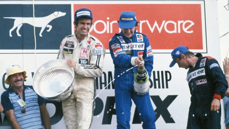Alain Prost, Rene Arnoux (both Renault) and Carlos Reutemann (Williams-Ford) on the podium after the 1982 South African Grand Prix