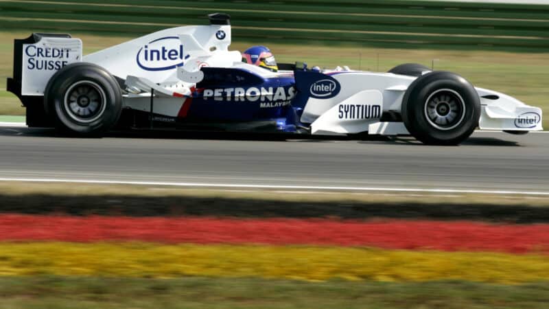 Jacques Villeneuve (BMW-Sauber) passing a German flag in practice for the 2006 German Grand Prix