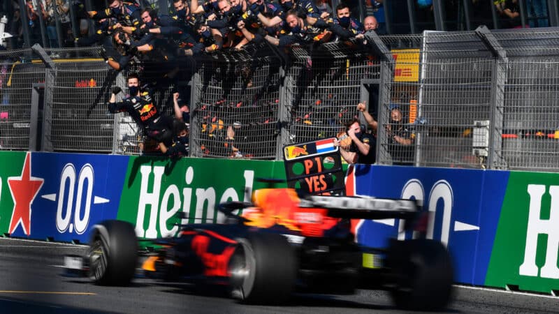 Red Bull-Honda mechanics and Christian Horner greet Max Verstappen as he crosses te line to win the 2021 Dutch Grand Prix
