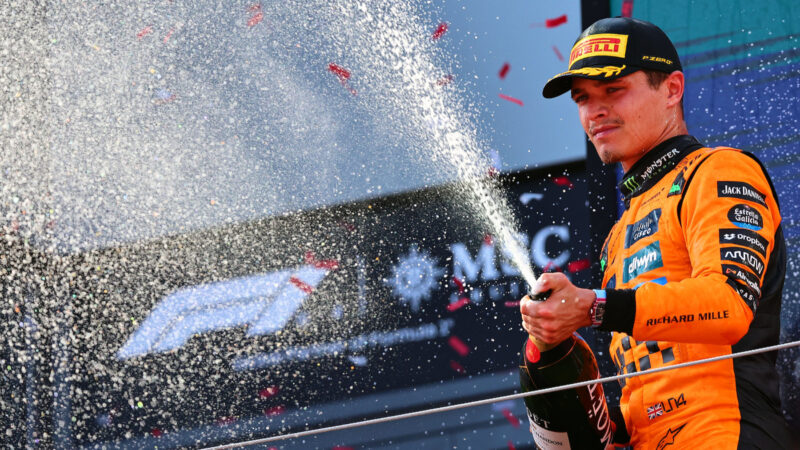 McLaren-Mercedes driver Lando Norris sprays the champagne on the podium after the 2025 Austrian Grand Prix