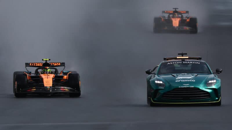 The safety car leads Lando Norris and Oscar Piastri at the Belgian GP