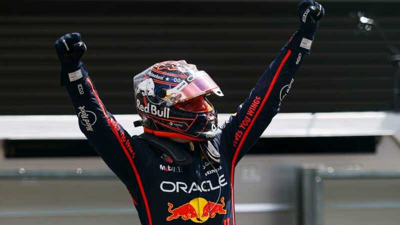 Max Verstappen holds arms in the air as he celebrates victory in the 2025 F1 Belgian GP sprint race