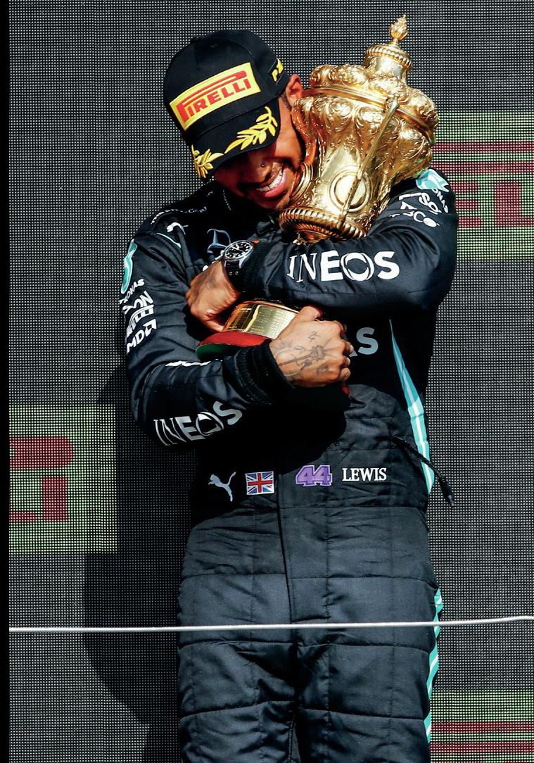 Lewis Hamilton holds the RAC trophy after winning the 2021 British Grand Prix
